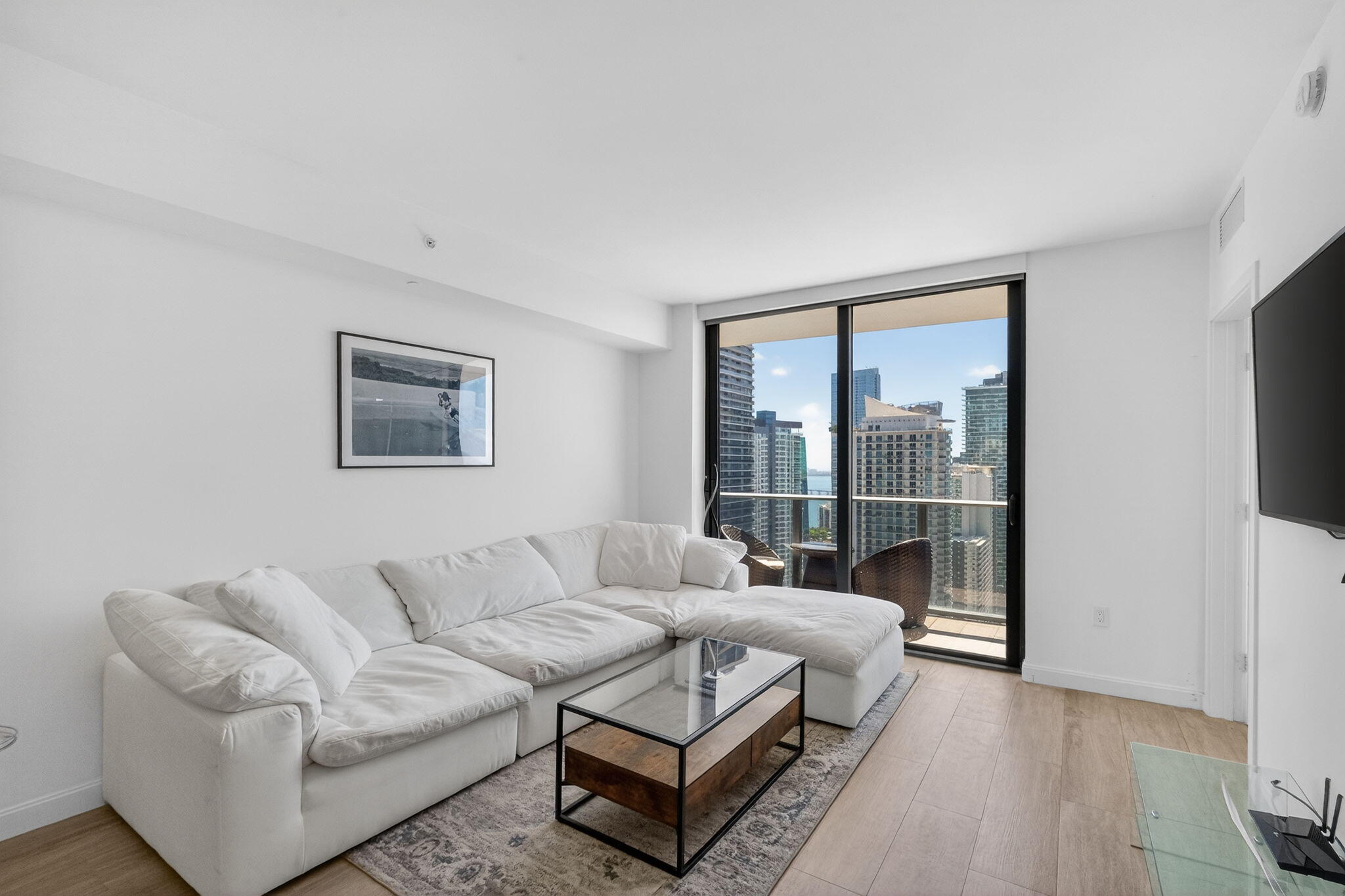 55 Southwest 9th Street, Unit 3704 Miami, FL 33130 - Photo 4 of 53 a living room with furniture and a floor to ceiling window
