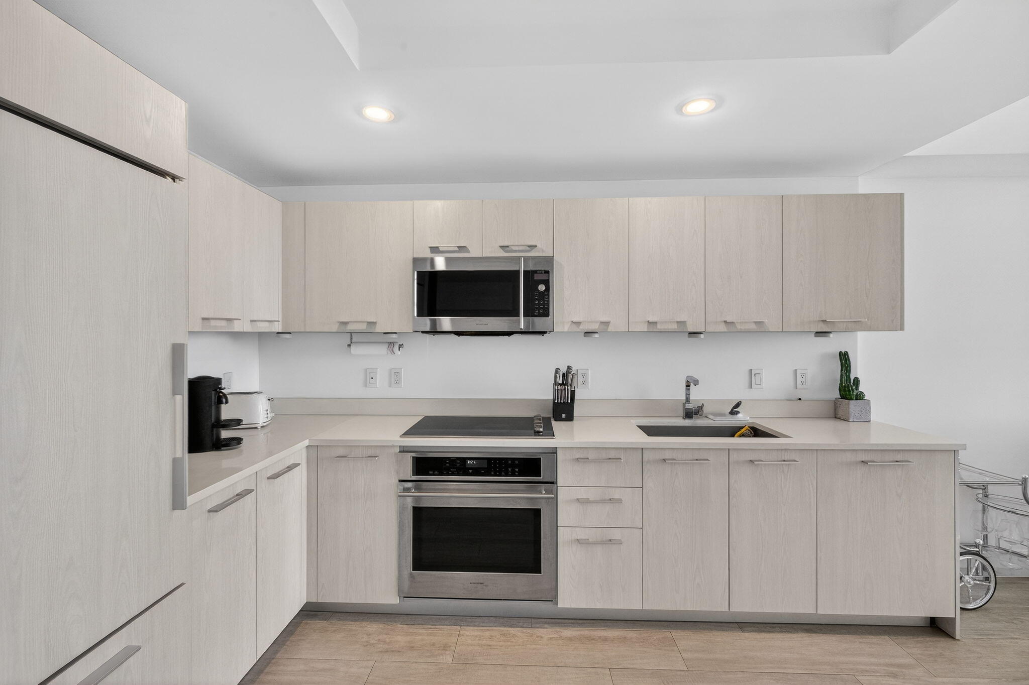 55 Southwest 9th Street, Unit 3704 Miami, FL 33130 - Photo 7 of 53 a kitchen with white cabinets and stainless steel appliances