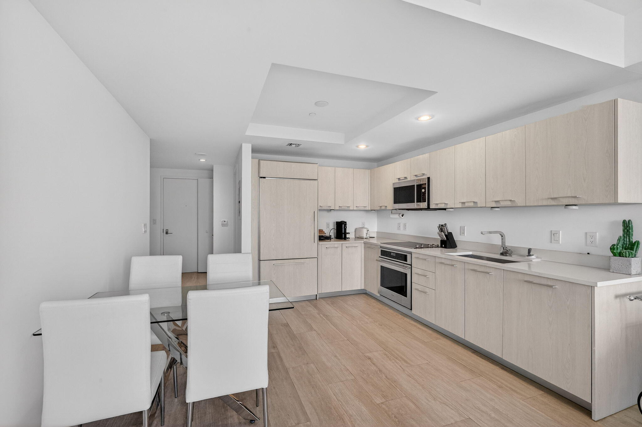 55 Southwest 9th Street, Unit 3704 Miami, FL 33130 - Photo 8 of 53 a kitchen with a white cabinets and white appliances