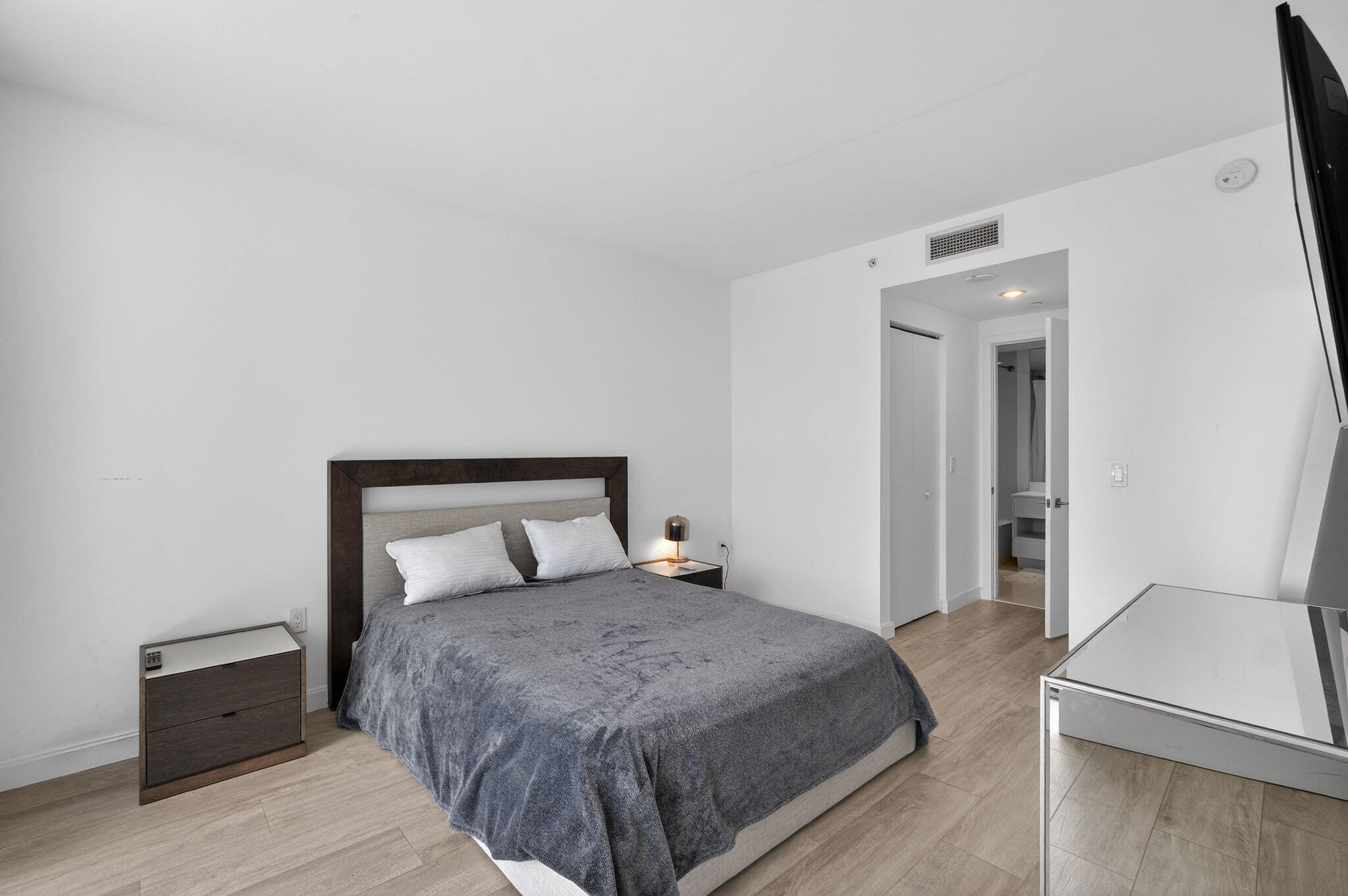 55 Southwest 9th Street, Unit 3704 Miami, FL 33130 - Photo 10 of 53 a bedroom with a bed and wooden floor