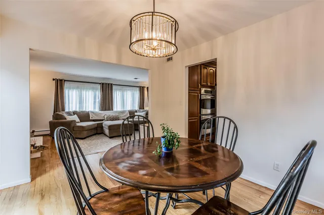 a view of a livingroom and dining room with wooden floor