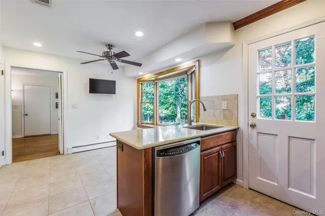 a kitchen with a sink and a stove top oven