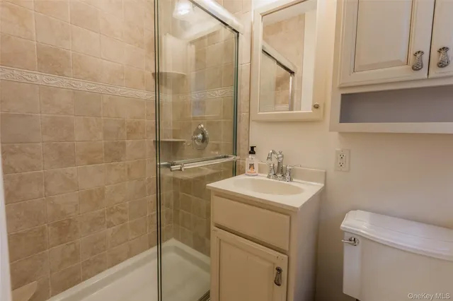 a bathroom with a sink toilet vanity and tub