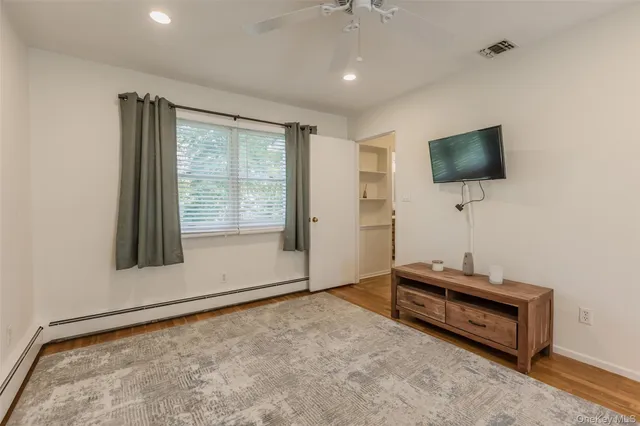 a living room with couch and a flat screen tv