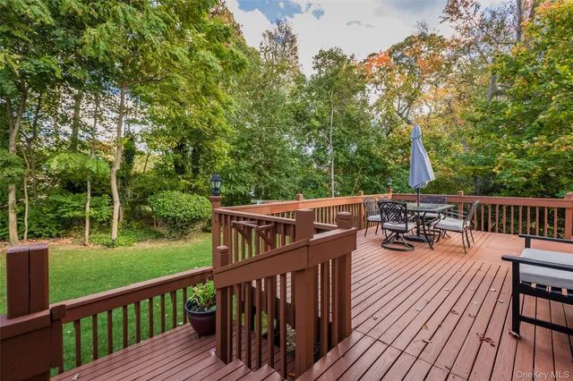 a view of backyard with a deck and wooden floor