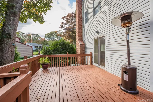 a view of deck with a table and chairs and wooden floor