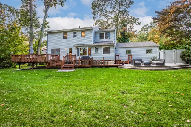 a view of a house with a yard and sitting area