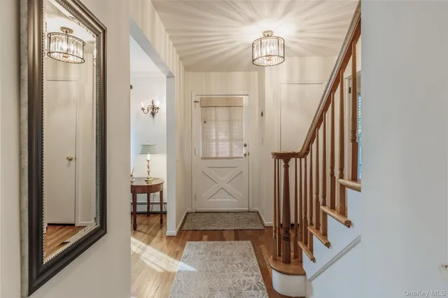a view of staircase with railing and chandelier