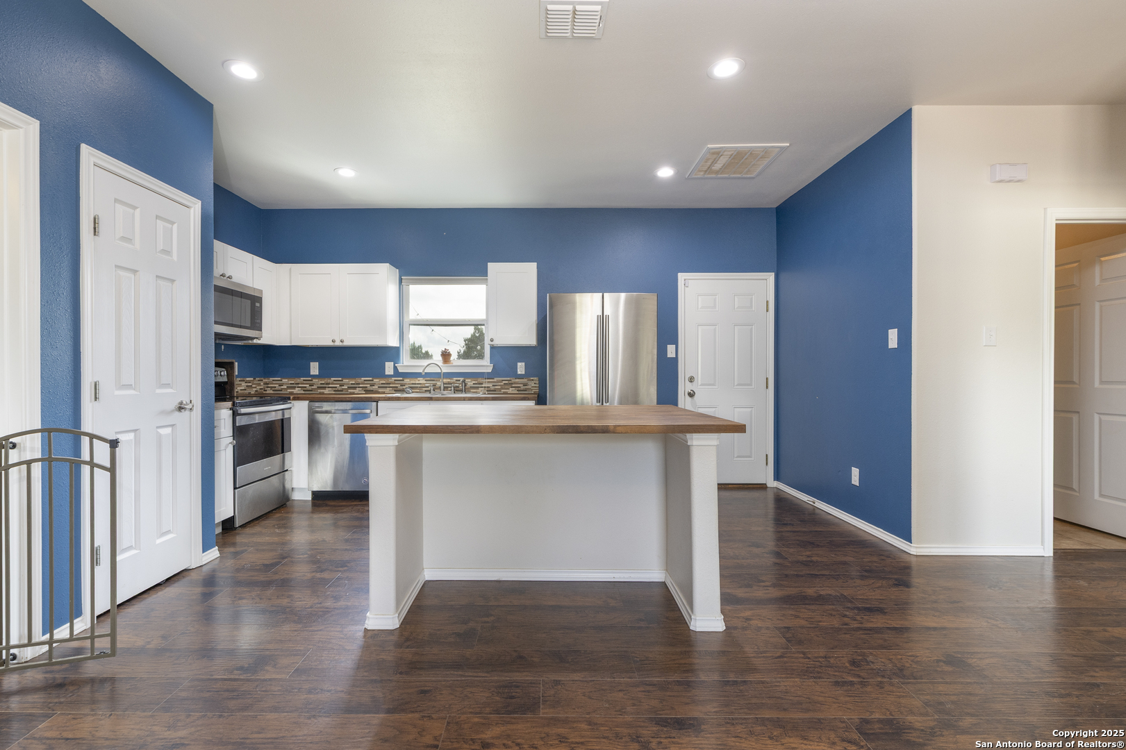 421 Cimarron Spring Branch, TX 78070 - Photo 11 of 29 a open kitchen with white cabinets and stainless steel appliances
