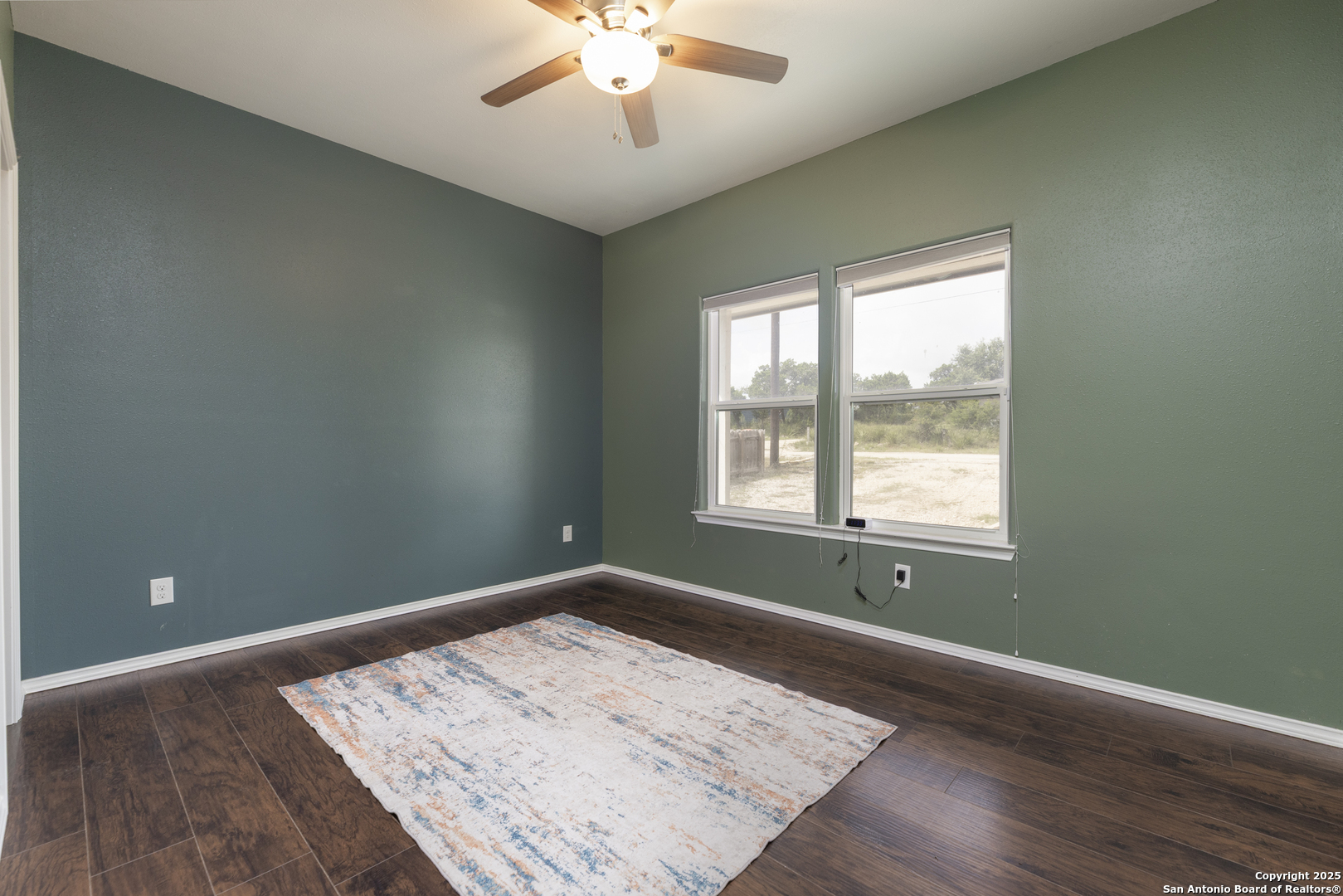421 Cimarron Spring Branch, TX 78070 - Photo 14 of 29 wooden floor in an empty room with a window