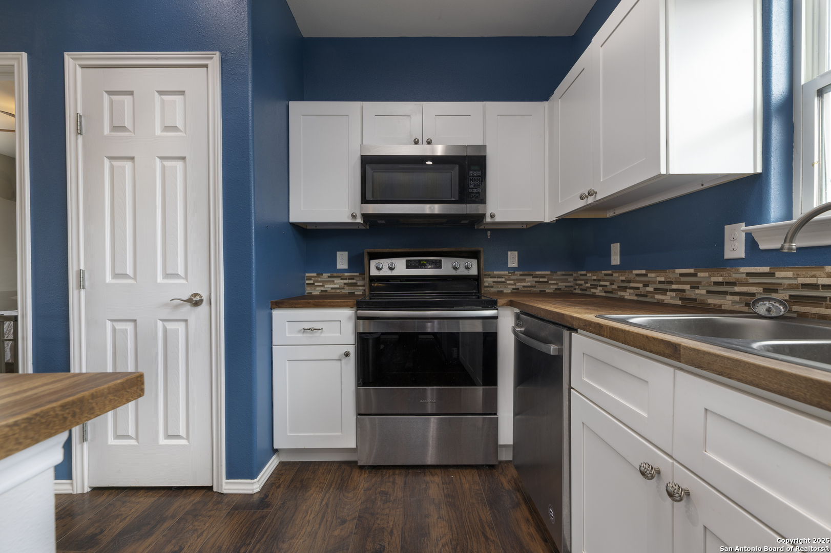 421 Cimarron Spring Branch, TX 78070 - Photo 9 of 29 a kitchen with a stove and a microwave