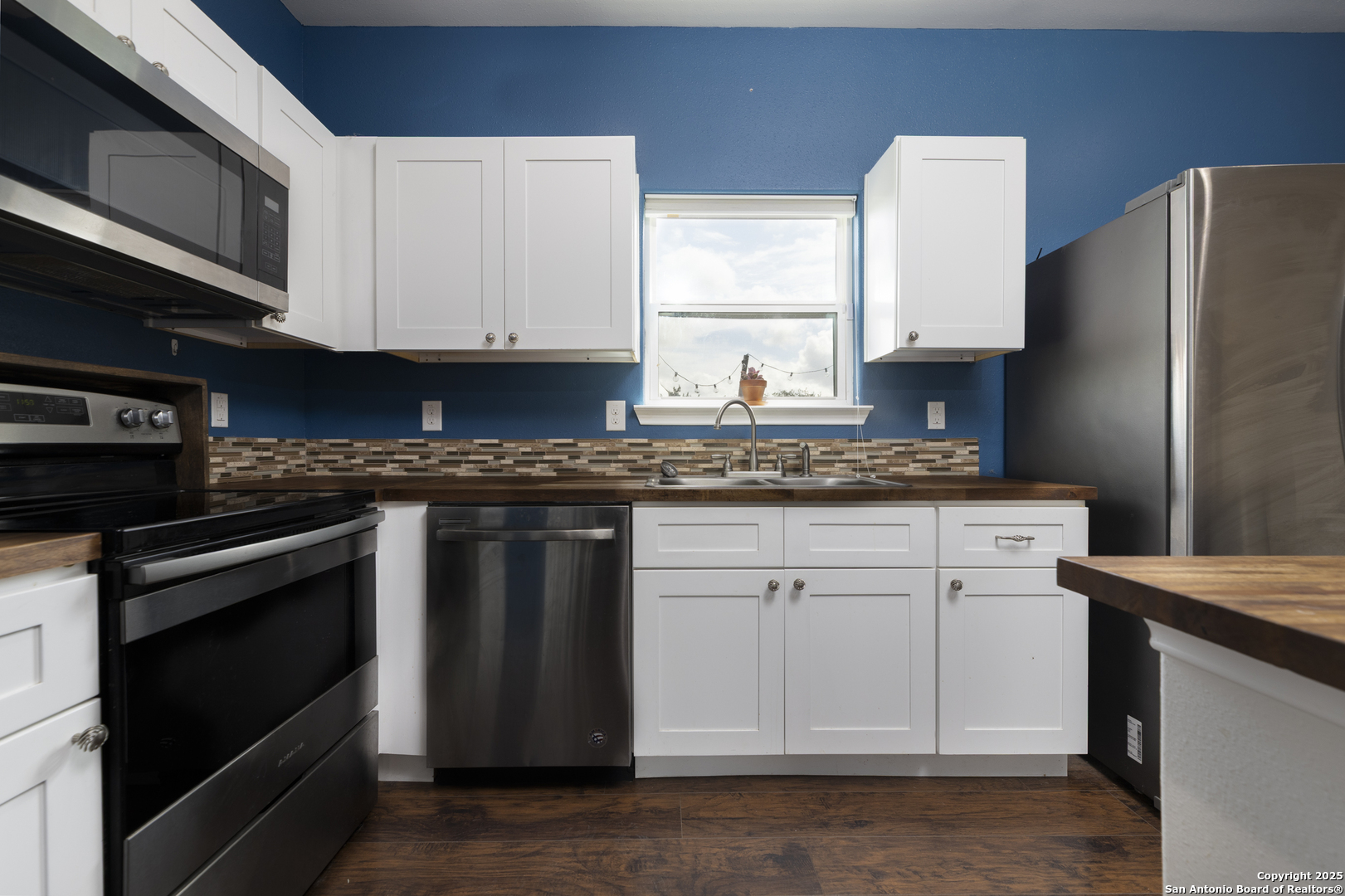421 Cimarron Spring Branch, TX 78070 - Photo 10 of 29 a kitchen with stainless steel appliances granite countertop a stove a refrigerator and a microwave