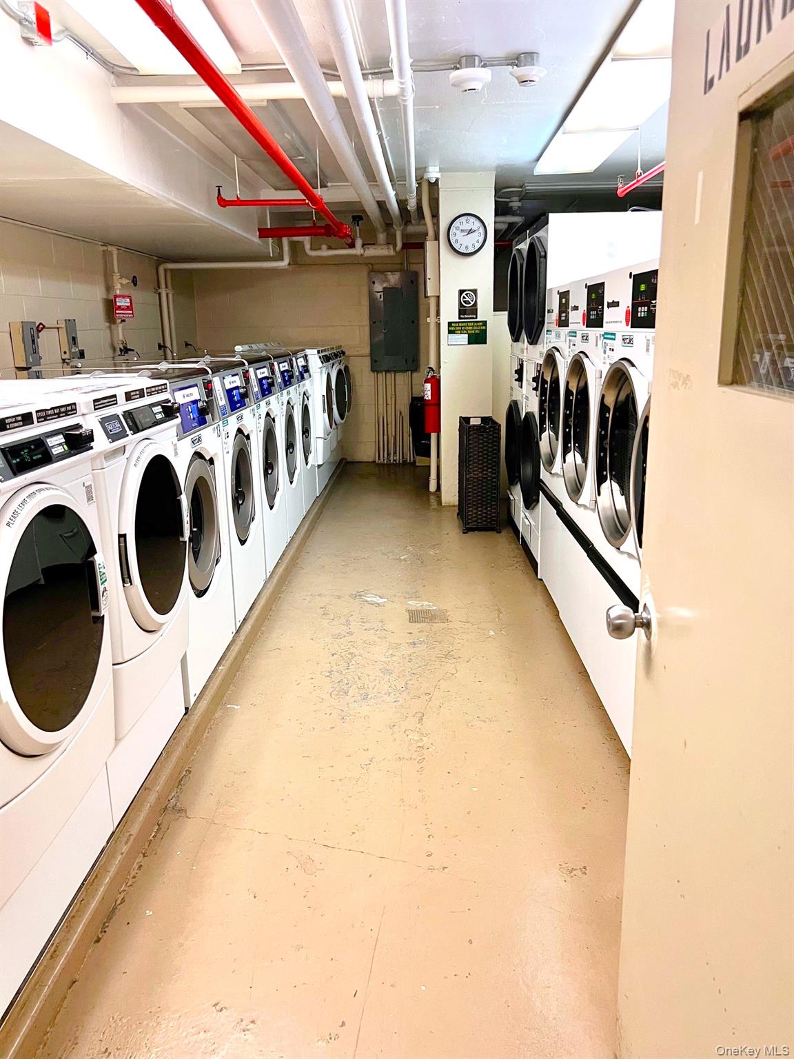 376 Broadway, Unit 11D Manhattan, NY 10013 - Photo 11 of 11 a utility room with dryer and washer