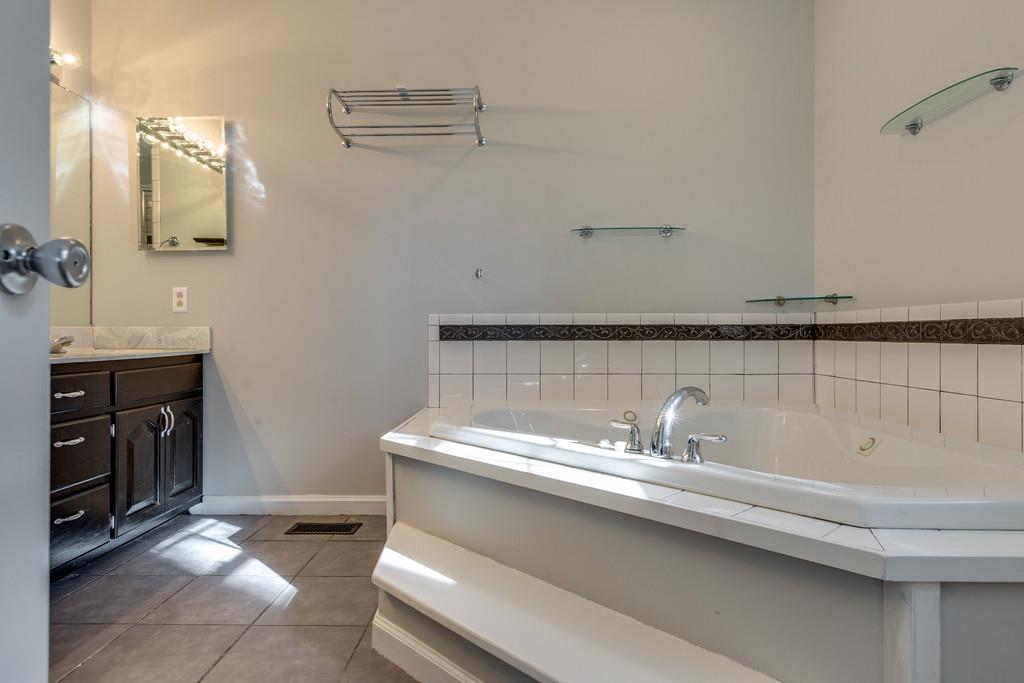 639 Vaughan's Gap Road Spring Hill, TN 37174 - Photo 11 of 19 a bathroom with a sink and a mirror