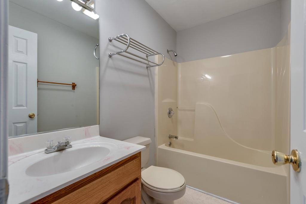 639 Vaughan's Gap Road Spring Hill, TN 37174 - Photo 14 of 19 a bathroom with a sink toilet tub and shower