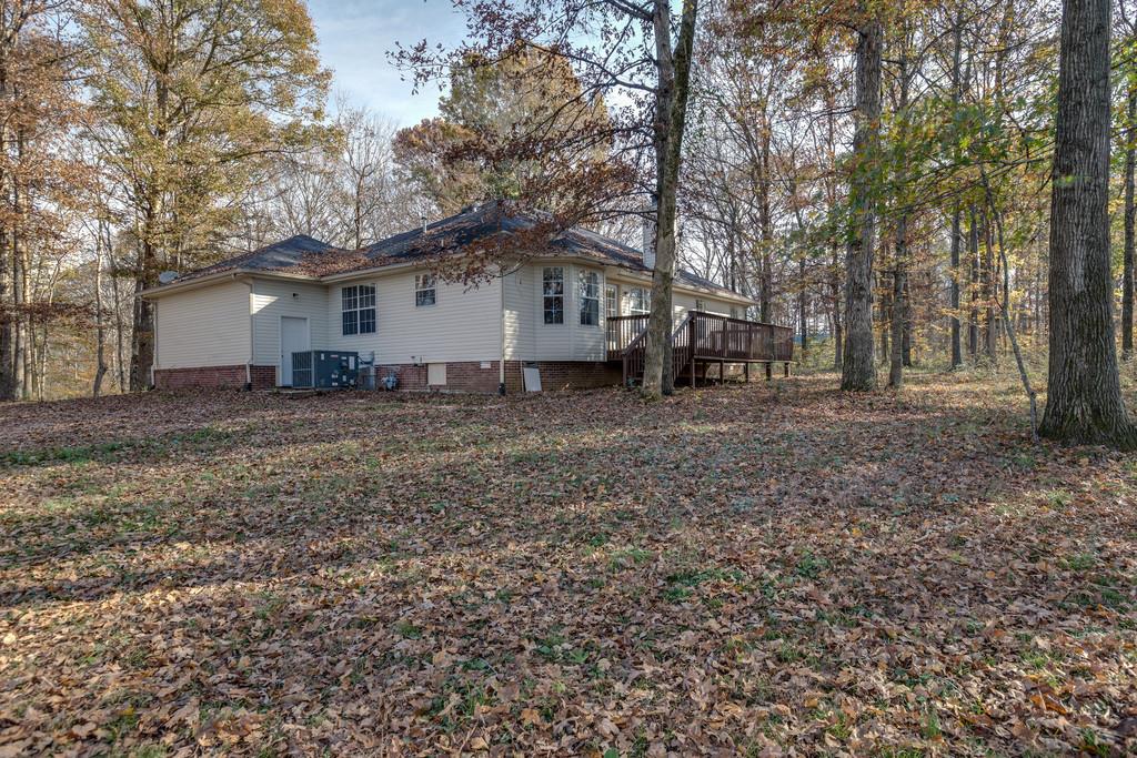 639 Vaughan's Gap Road Spring Hill, TN 37174 - Photo 18 of 19 a white house that has a tree in front of it