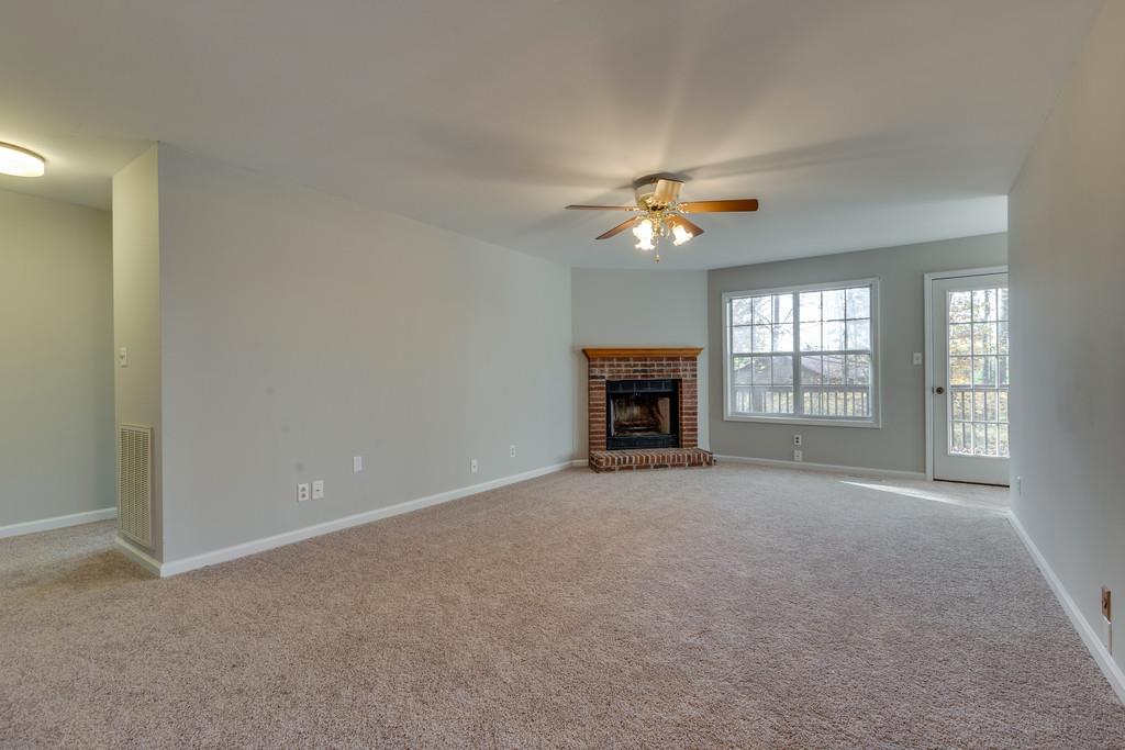 639 Vaughan's Gap Road Spring Hill, TN 37174 - Photo 2 of 19 an empty room with chandelier fan and fireplace