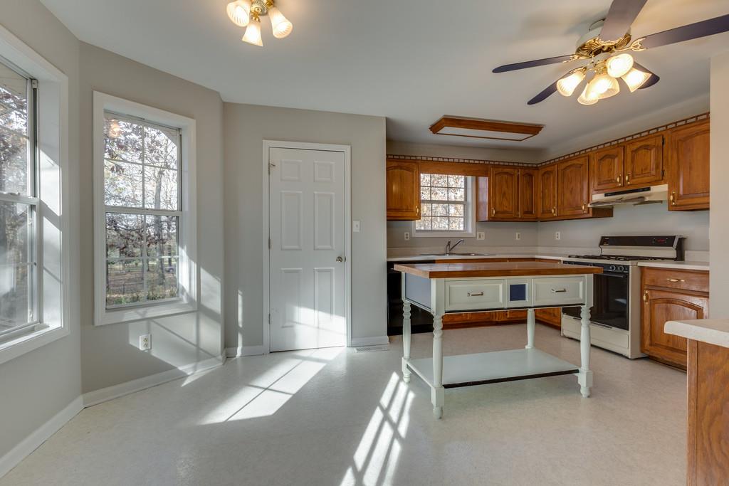 639 Vaughan's Gap Road Spring Hill, TN 37174 - Photo 6 of 19 a kitchen with stainless steel appliances granite countertop a stove and a refrigerator