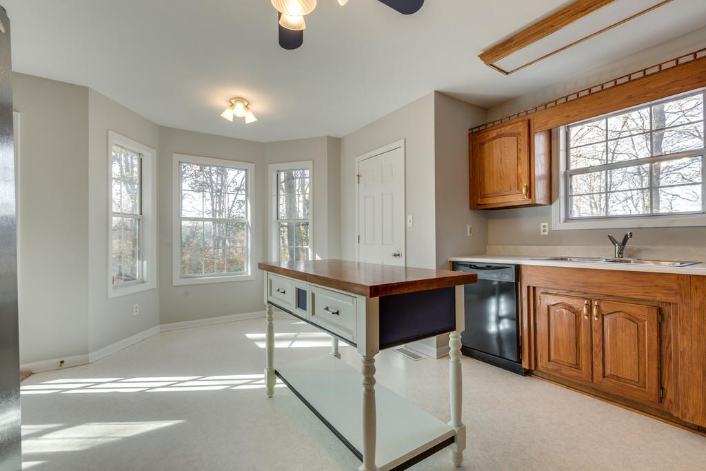 639 Vaughan's Gap Road Spring Hill, TN 37174 - Photo 8 of 19 a spacious kitchen with stainless steel appliances granite countertop a stove a sink and a granite counter tops