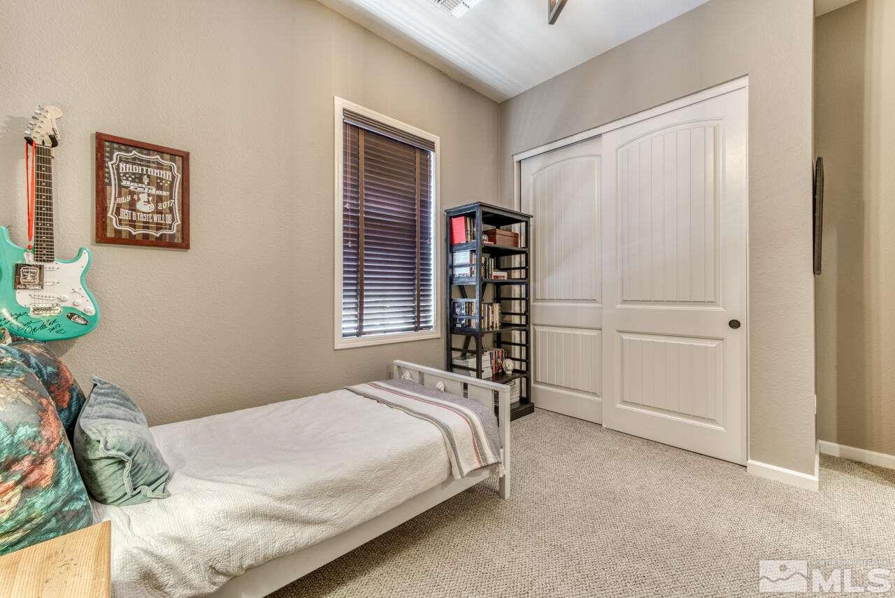 9525 Hawkshead Road Reno, NV 89521 - Photo 27 of 36 a bed sitting in a bedroom next to a window