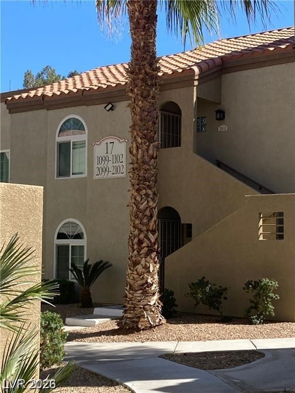 3145 East Flamingo Road, Unit 2100 Las Vegas, NV 89121 - Photo 2 of 34 A desert-friendly landscape surrounds this multi-level residential building with terracotta tile roofing.