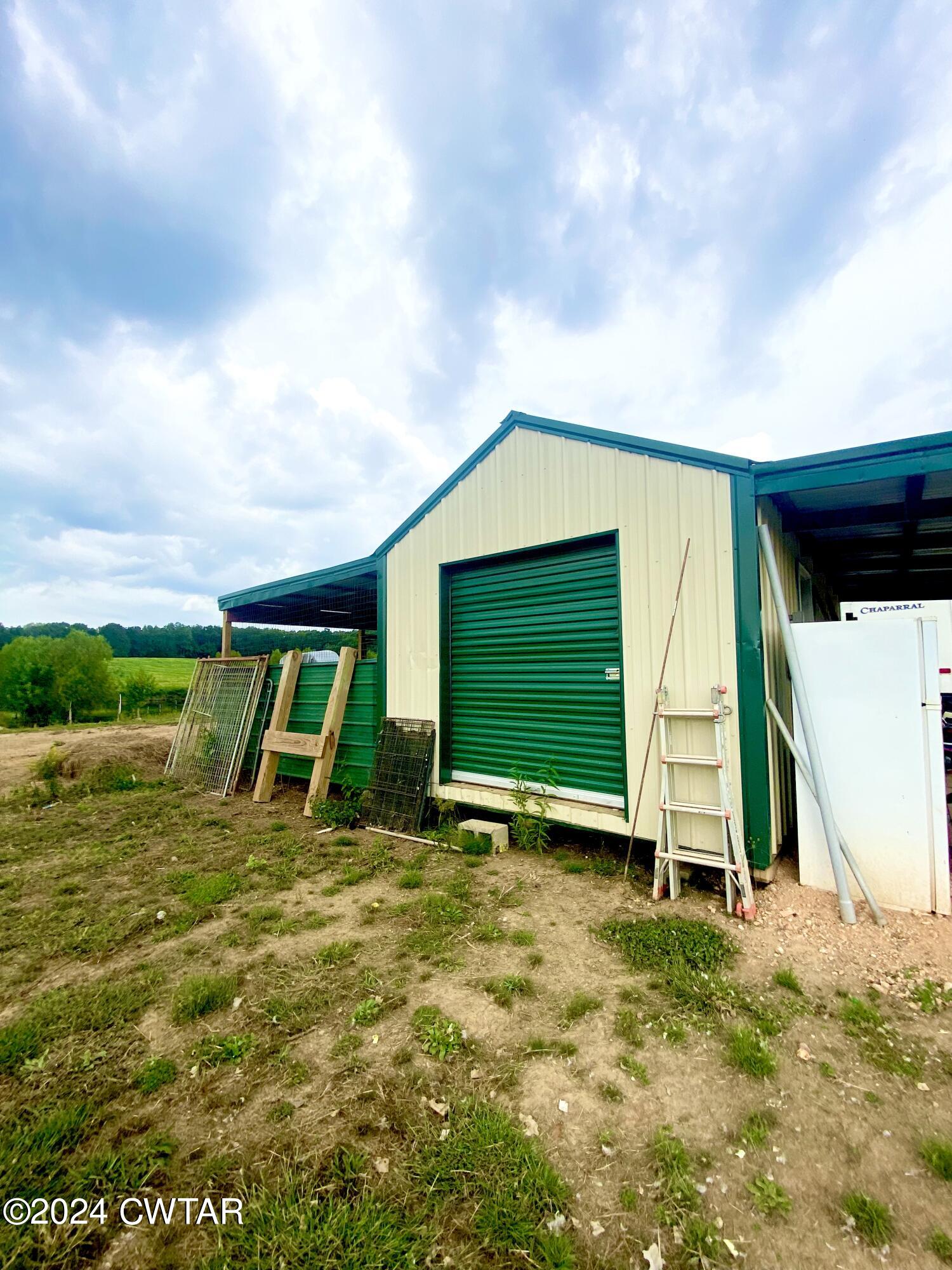 4474 Flatwoods Road Camden, TN 38320 - Photo 17 of 18 a view of outdoor space with deck and flat screen tv