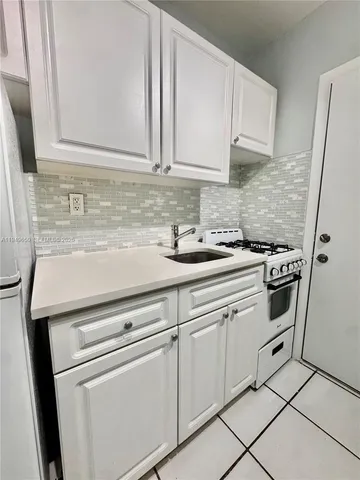 a house view with a sitting space and garden