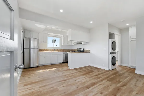 a kitchen with refrigerator and cabinets
