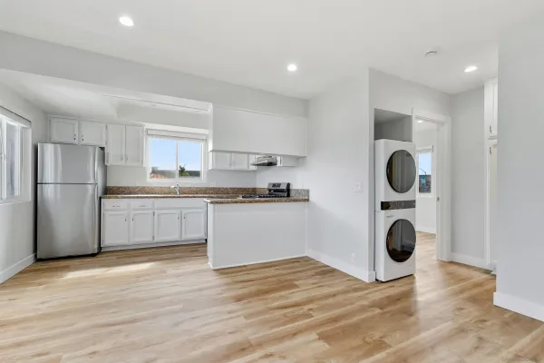 a kitchen with stainless steel appliances granite countertop a refrigerator sink and cabinets