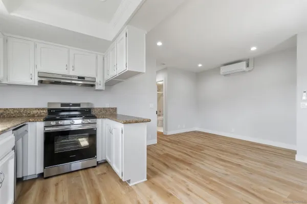 a kitchen with stainless steel appliances granite countertop a stove and a refrigerator