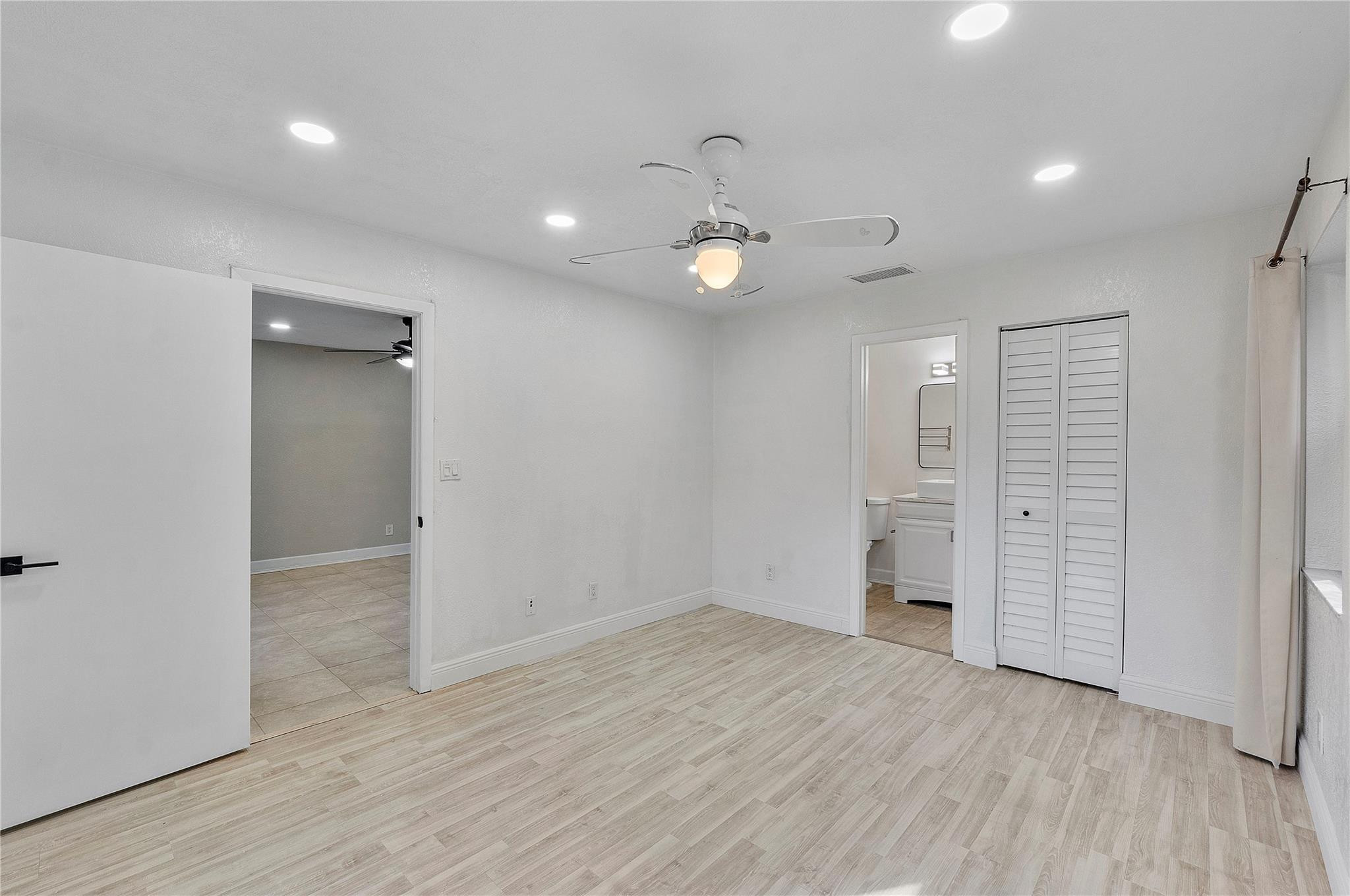 5290 Gate Lake Road, Unit 5290 Tamarac, FL 33319 - Photo 16 of 18 an empty room with wooden floor and ceiling fan