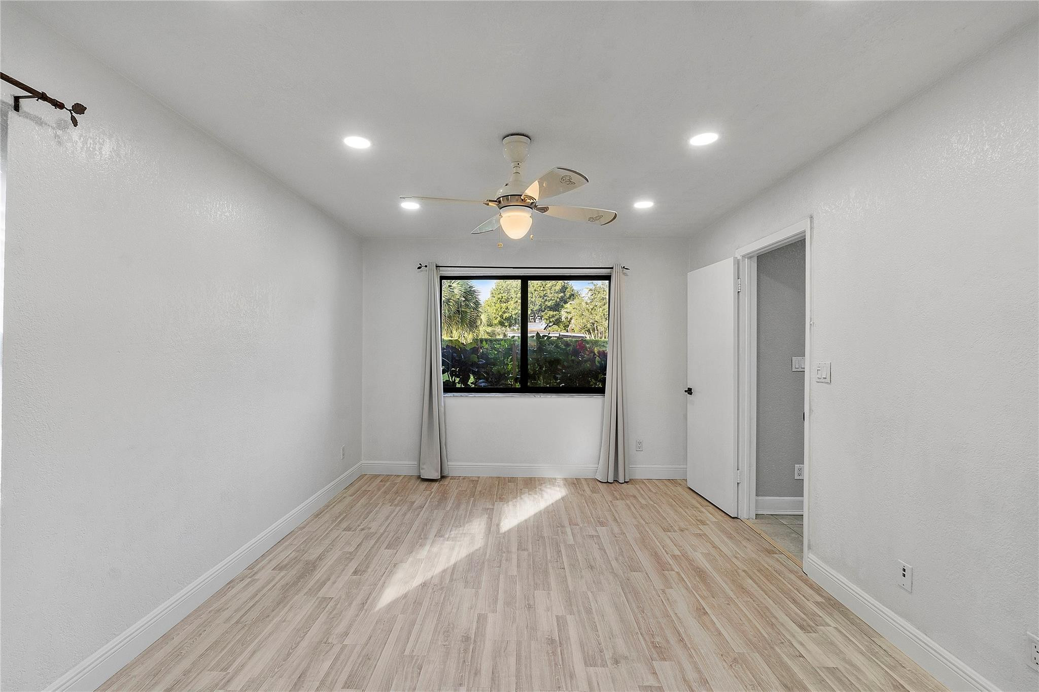 5290 Gate Lake Road, Unit 5290 Tamarac, FL 33319 - Photo 17 of 18 a view of an empty room with a window