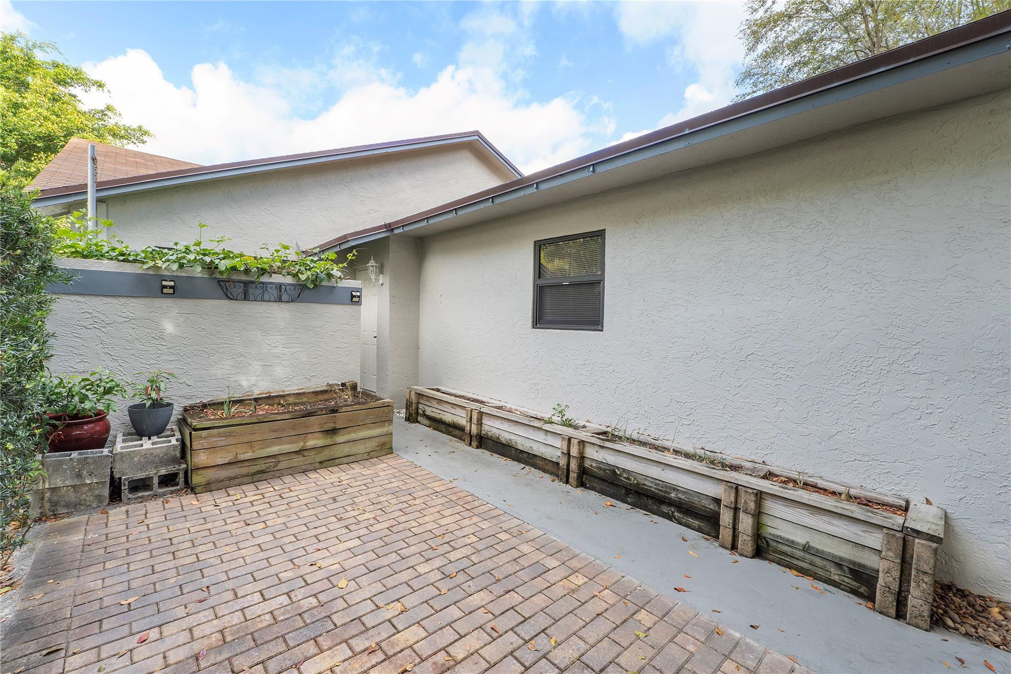 5290 Gate Lake Road, Unit 5290 Tamarac, FL 33319 - Photo 3 of 18 a view of a terrace with outdoor seating and plants