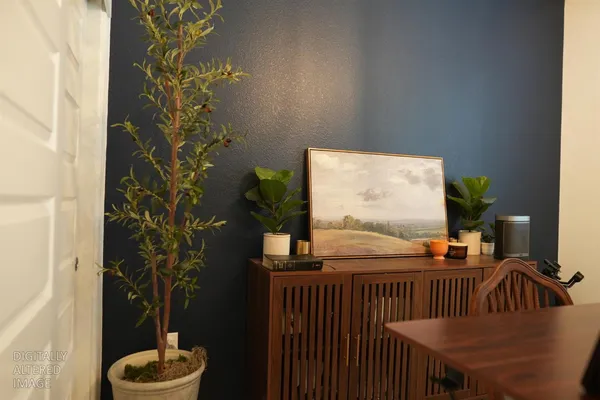 a view of a dining room with a table and chairs