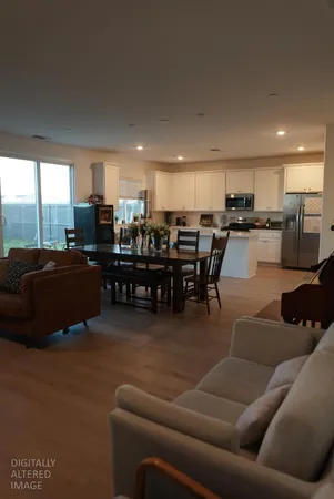 a living room with furniture and kitchen view