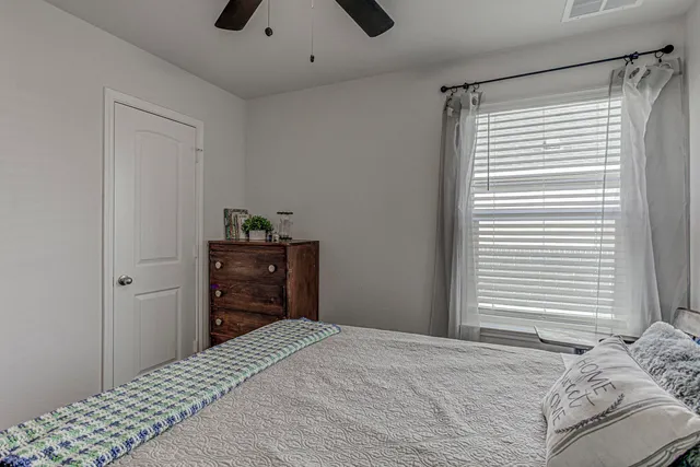 a bedroom with a bed and a dresser