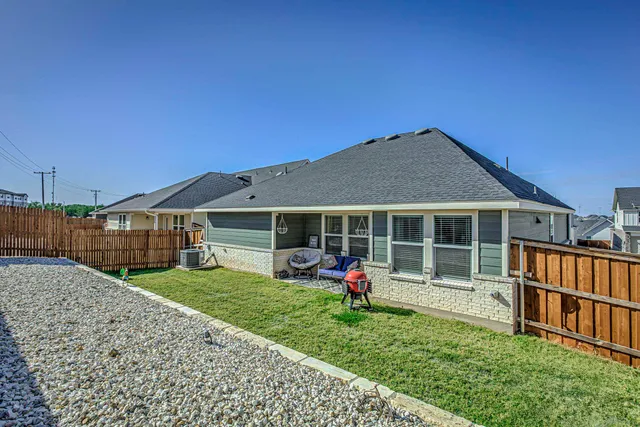 a view of a house with a yard and porch