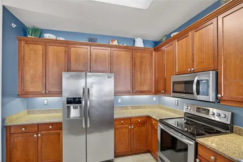 a kitchen with a refrigerator stove and microwave