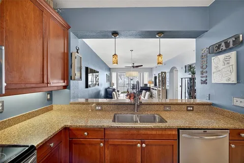 a kitchen with stainless steel appliances granite countertop a sink and cabinets