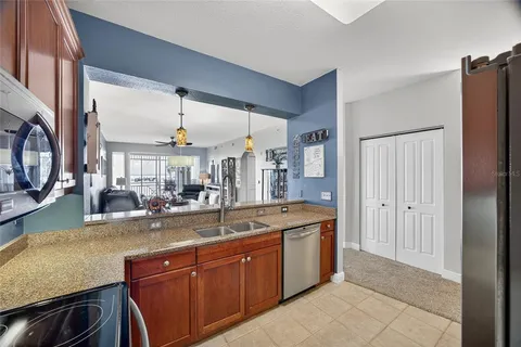 a dining hall with stainless steel appliances granite countertop a sink and dishwasher