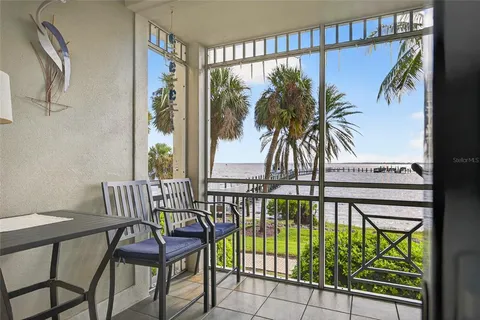 a view of a chairs and table in the balcony