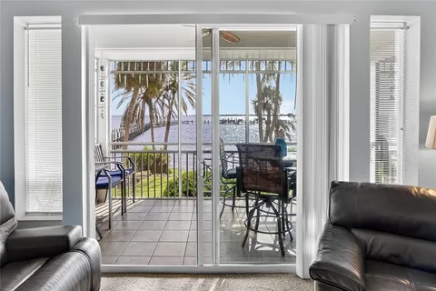 a living room with furniture and a floor to ceiling window