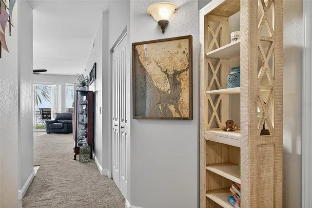 a view of a hallway with living room and a window
