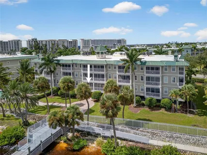 a sign board with buildings in the background