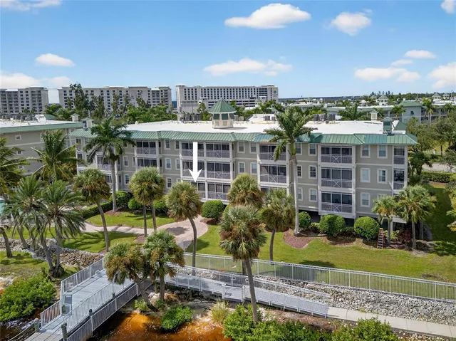 a sign board with buildings in the background