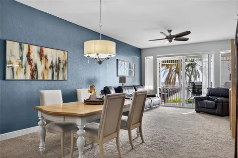 a view of a livingroom with furniture window and a ceiling fan