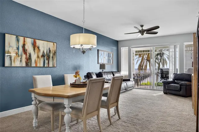 a view of a livingroom with furniture window and a ceiling fan