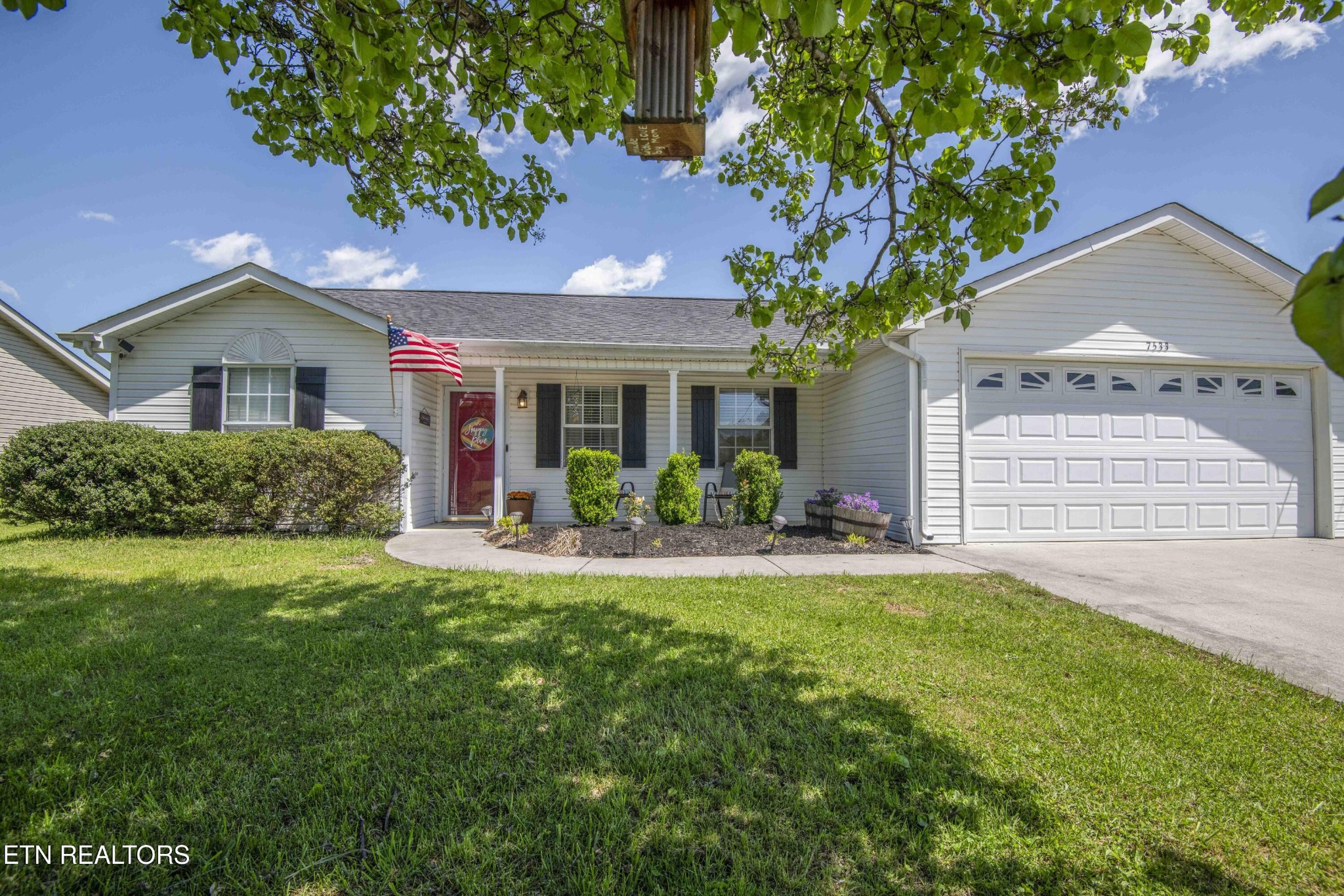 a front view of a house with a yard and garage