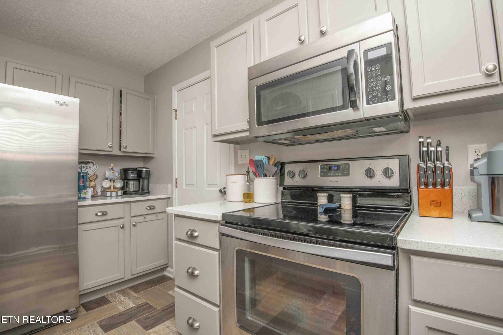 7533 Gary White Road Corryton, TN 37721 - Photo 11 of 44 a kitchen with stainless steel appliances granite countertop a stove microwave and cabinets