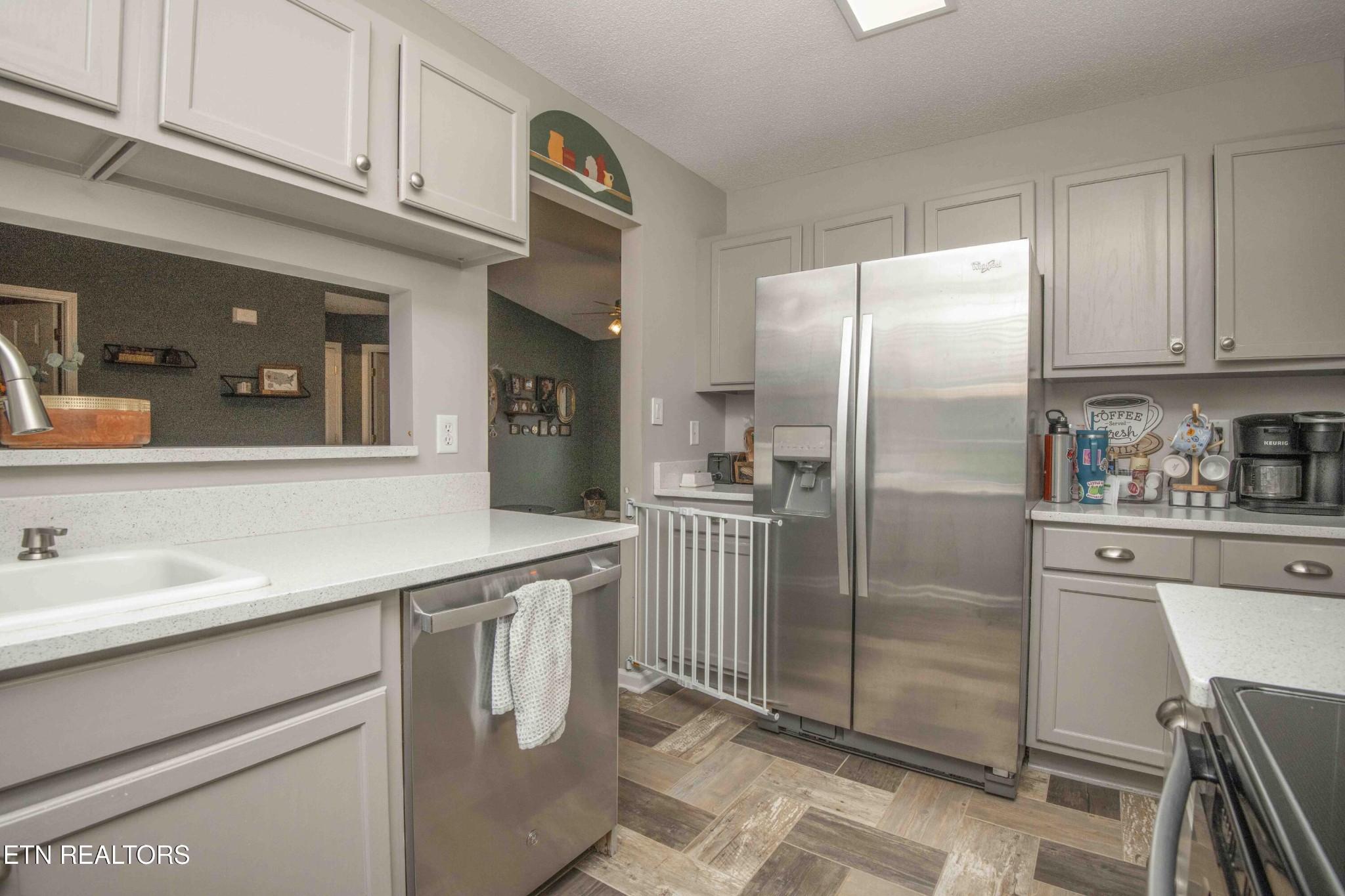 7533 Gary White Road Corryton, TN 37721 - Photo 15 of 44 a kitchen with stainless steel appliances granite countertop a refrigerator a sink and white cabinets